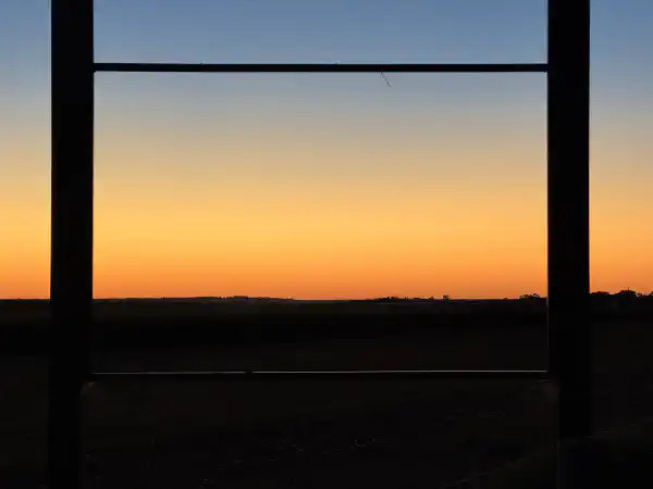 sunset, viewed through a metal frame