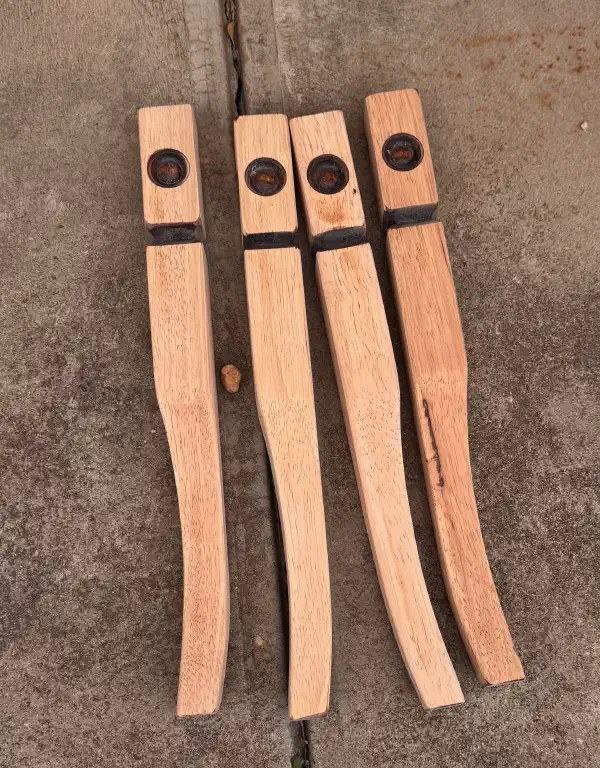 four table legs on the ground, sanded to bare wood
