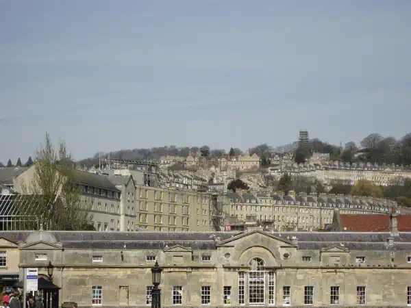 A view from ground level, up a hill which is densely packed with many houses and other buildings